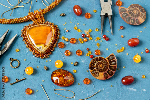 Amber cabochons, amonites, beads for making jewelry and amber necklaces. photo