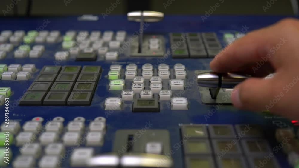 Broadcast Tv Studio Production - Vision Switcher Studio Director broadcast video mixer operation - Close-up of hand. Hands of a cinematographer who worked on the vision mixer, switch the TV panel. Broadcast Tv Studio Production - Vision Switcher Studio Director broadcast video mixer operation - Close-up of hand. Hands of a cinematographer who worked on the vision mixer, switch the TV panel.