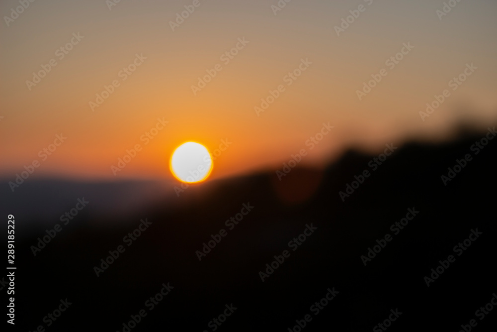 Plakat As a visually impaired person sees the sun at sunset. An example of how visually impaired people see it. Without glasses, I see so. Beautiful blurred sunset. Abstract background for illustrations.