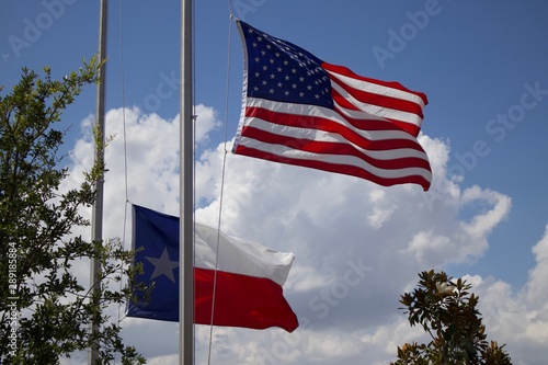 American and Texas Flags Flying At Half Mass