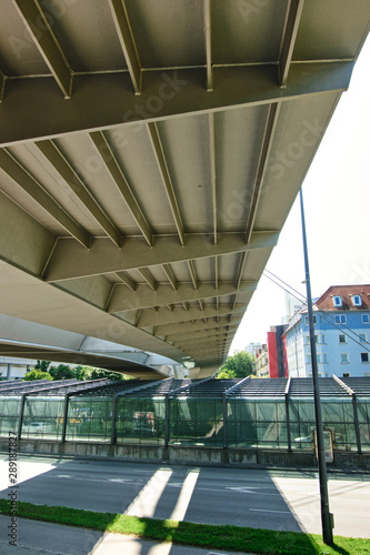 Bridge for pedestrians and tram, which leads in Munich over a main road. Glazing the driveway to a road tunnel.