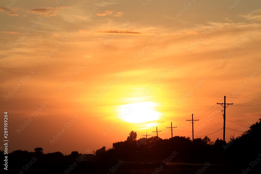 Kansas Sunset with a colorful Sky and Power Lines Silhouette's. Kansas Sunset with a colorful Sky and Power Lines Silhouette's.