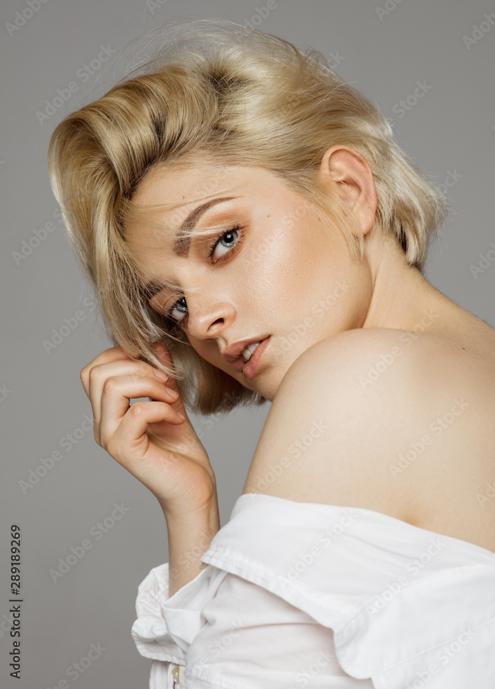 Portrait of beautiful blonde woman in white shirt and messy hair Portrait of beautiful blonde woman in white shirt and messy hair