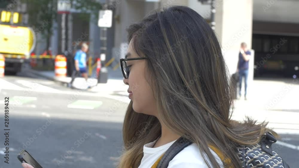 Young Woman Crosses Street in City while Texting Phone Young Woman Crosses Street in City while Texting Phone