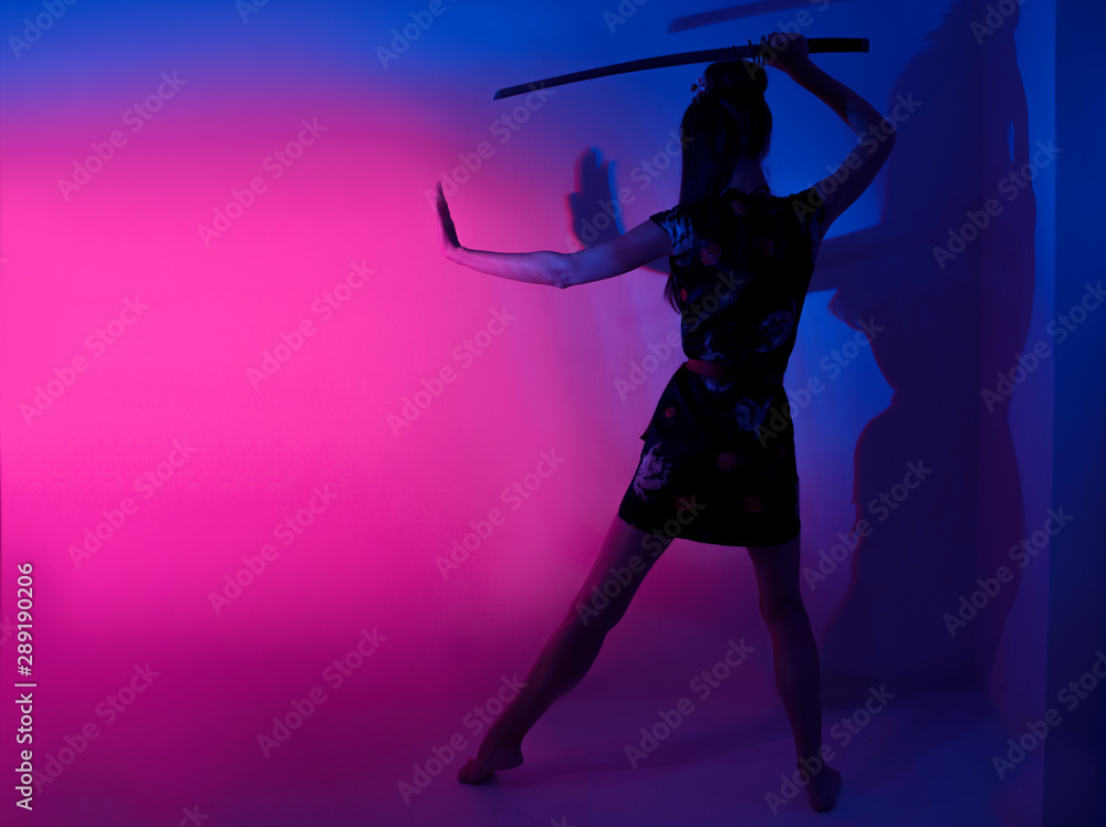 Barefoot female posing with samurai sword abstract light background Barefoot female posing with samurai sword abstract light background