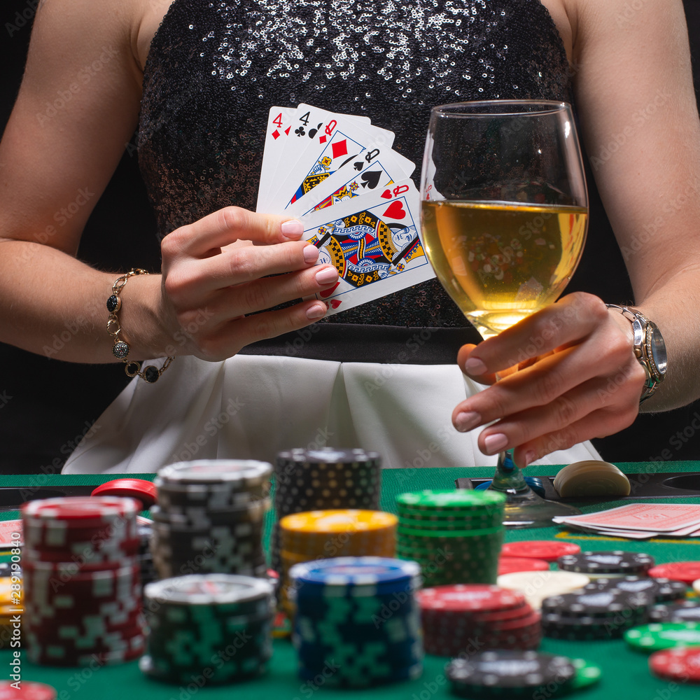 A woman plays in a casino. shows a winning combination on cards. Winning poker A woman plays in a casino. shows a winning combination on cards. Winning poker