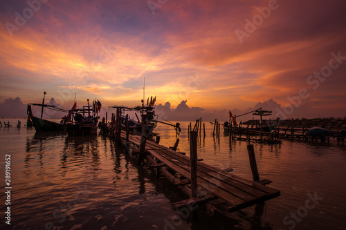 Panoramic wallpaper of the morning light scenery by the sea  with small fishing boats of the villagers landing  with blurred waves of sea  a beautiful way of life by the river community