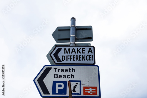 Writing note showing Make A Difference. Business concept for have significant effect or non on demonstrating or situation Business concept with empty copy space on the road sign photo