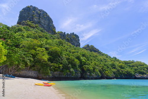 Landscape view of colourful kayaks and stand up paddle boarding on a tropical sandy beach,blue turquoise water, lush green jungle and high mountain,Ang Thong National Marine Park,Surat Thani, Thailand