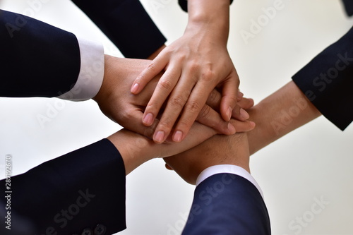 Wallpaper Mural Many business people are joining hands together. It is a sign of business collaboration, cooperation concept. Torontodigital.ca
