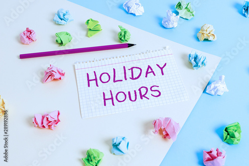Text sign showing Holiday Hours. Business photo text employee receives twice their normal pay for all hours Colored crumpled papers empty reminder blue yellow background clothespin
