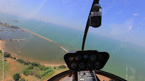 Helicopter inside view. Helicopterr fly over beach
