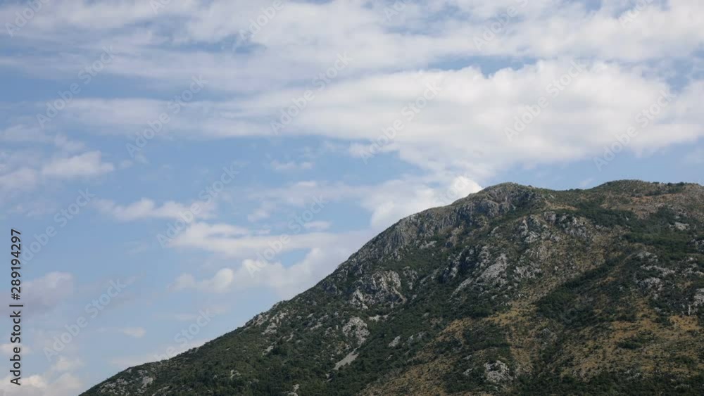 Time lapse of clouds on the mountain top with shadows of the clouds on the hill - Kotor bay Montenegro Time lapse of clouds on the mountain top with shadows of the clouds on the hill - Kotor bay Montenegro