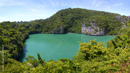 Thale Nai lagoon, the famous salt water Emerald Lake surrounded by lush tropical mountain green trees and lime stone rock cliff in Mae Koh island, Ang Thong National Marine Park, Suratthani,Thailand 