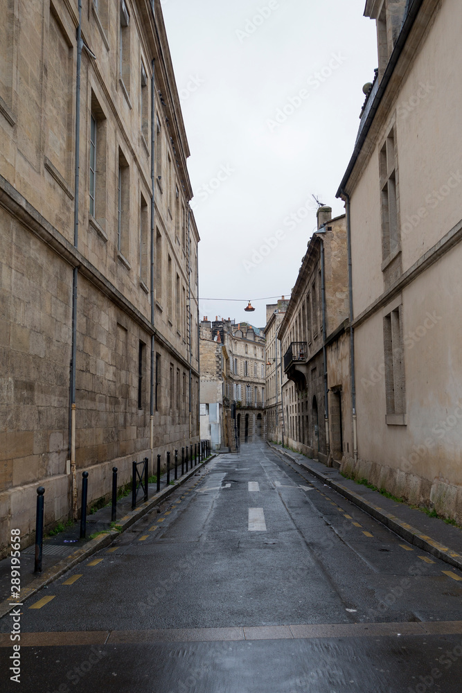 Empty street lined with old buildings in Bordeaux