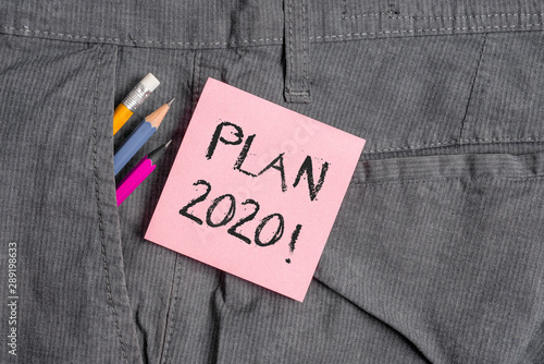 Conceptual hand writing showing Plan 2020. Concept meaning detailed proposal doing achieving something next year Writing equipment and pink note paper inside pocket of trousers
