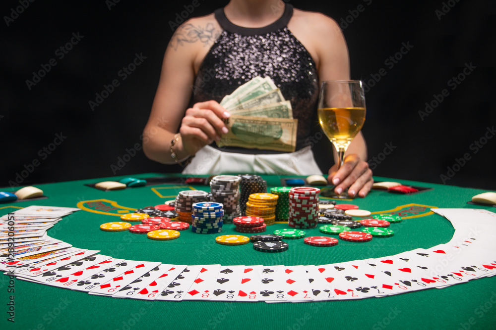 Background of a gaming casino, poker table, cards, chips and a girl with a  glass of wine in the background. Background for a gaming business, success  Stock Photo | Adobe Stock