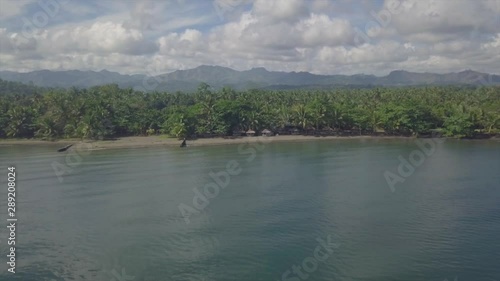 Forward Aerial shot of Cabagtucan Nasipit Agusan Del Norte Philippines Beach and Mountains photo