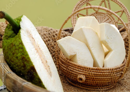 Close up breadfruit cut in half and slice on yellow background photo