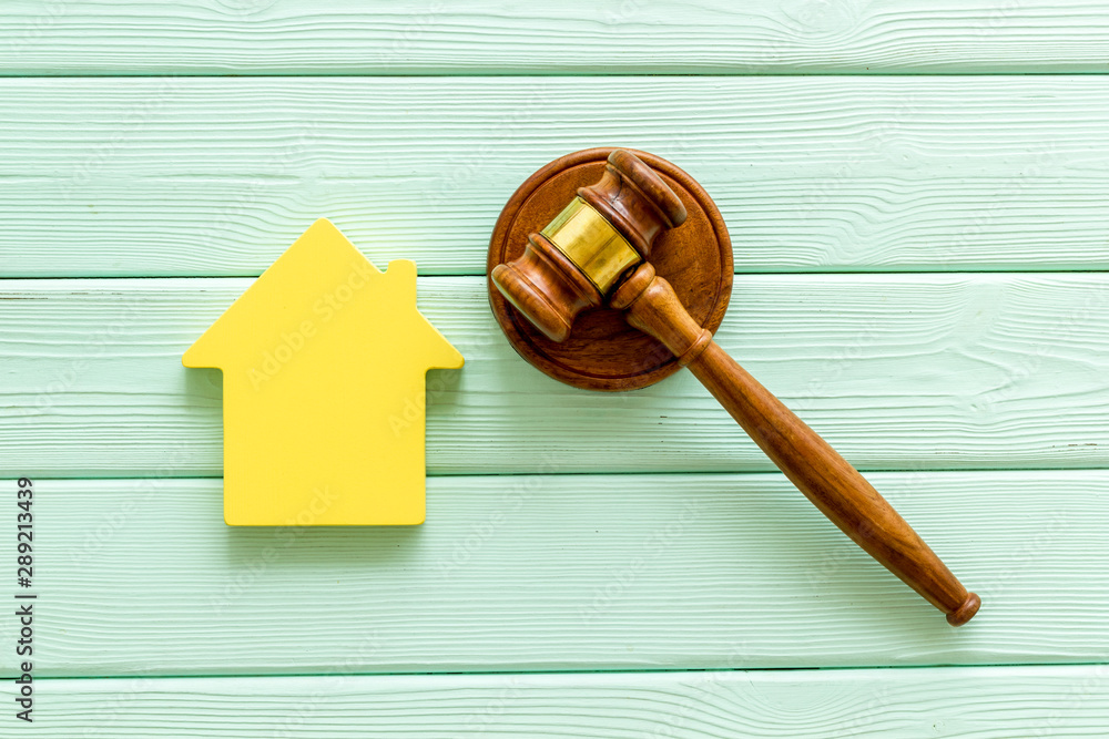 Inscribed gavel, house figure for inheritance concept on mint green wooden background top view Inscribed gavel, house figure for inheritance concept on mint green wooden background top view