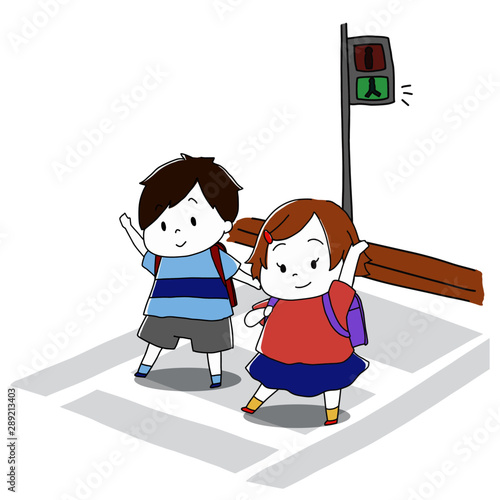 横断歩道を手を挙げて渡る小学生