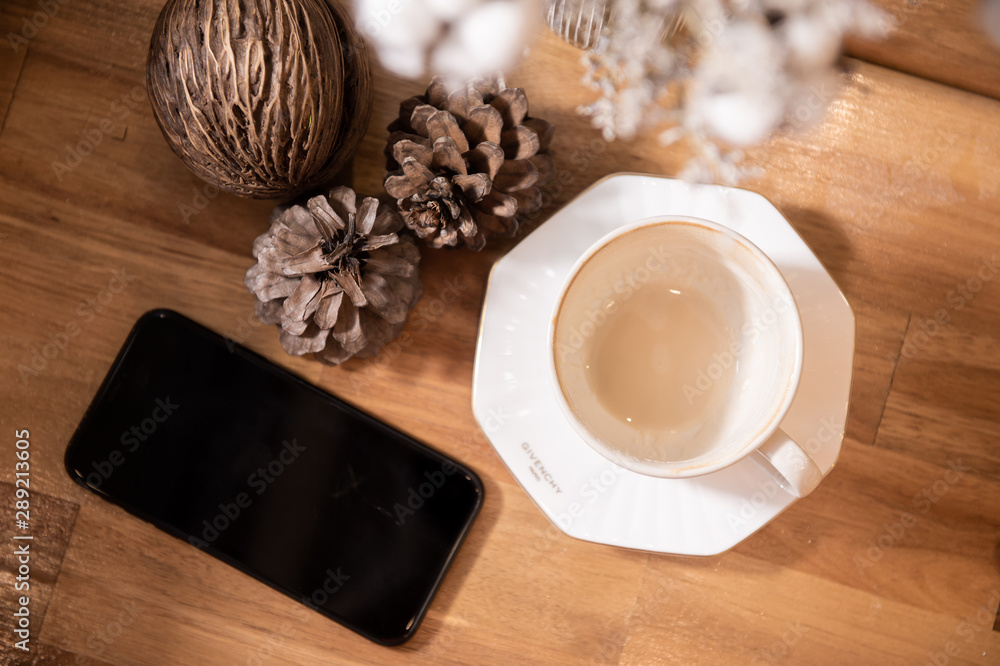 Coffee cup and smartphone on wooden table. Empty coffee cup. Coffee cup and smartphone on wooden table. Empty coffee cup.