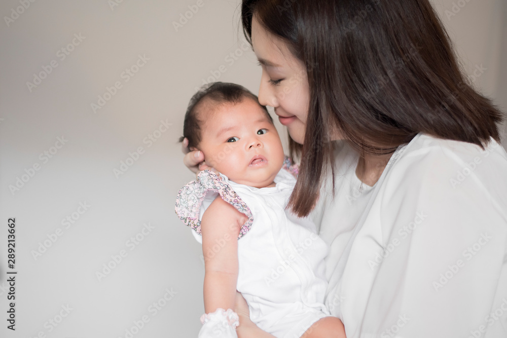 Beautiful woman holding a newborn baby in her arms Beautiful woman holding a newborn baby in her arms