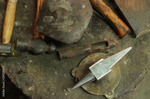 traditional worn and well used fine silversmiths tools on a craftsmans work bench in a work shop, Northern Thailand