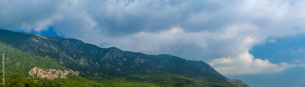 Naklejka premium Landscape with mountains and clouds