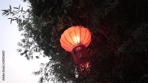 Red Asian lamp found in the trees. photo