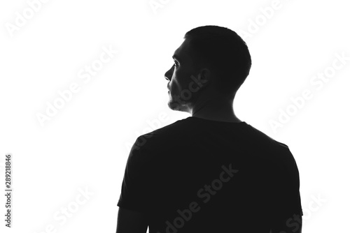 silhouette of man from behind on a white background looks away photo