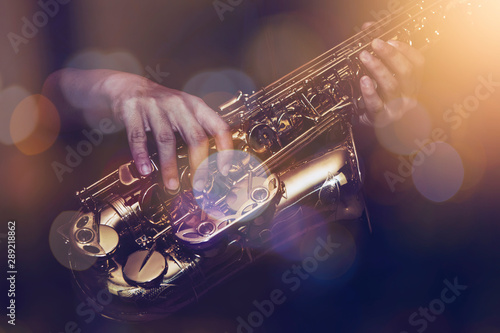 Photography close up of saxophone player plays saxophone  with music concert light and Bokeh