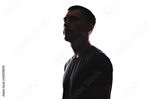 Silhouette portrait of young European man in profile isolated on white background