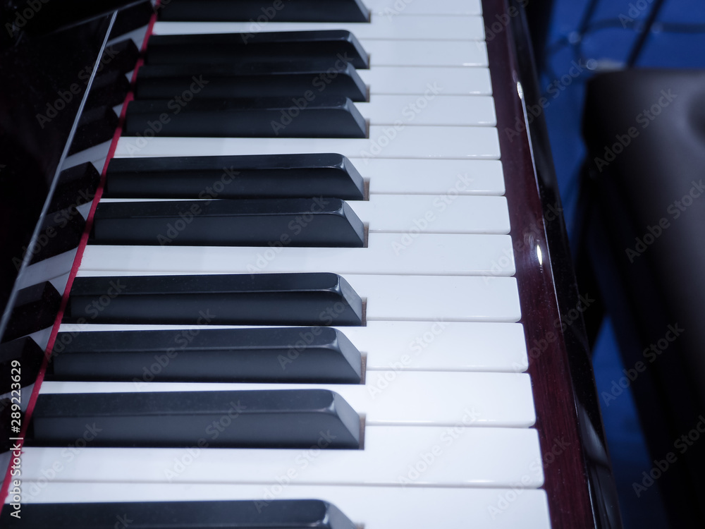 Shiny grand piano ebony and ivory keys. Details of a keyboard of a piano. Shiny grand piano ebony and ivory keys. Details of a keyboard of a piano.
