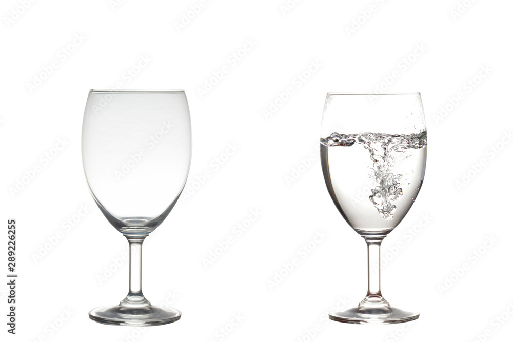Empty,half water in wine glasses . Isolated on white Empty,half water in wine glasses . Isolated on white