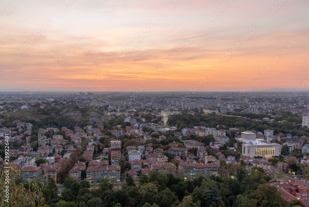 Beautiful sunrise with pink and yellow clouds above Plovdiv city 