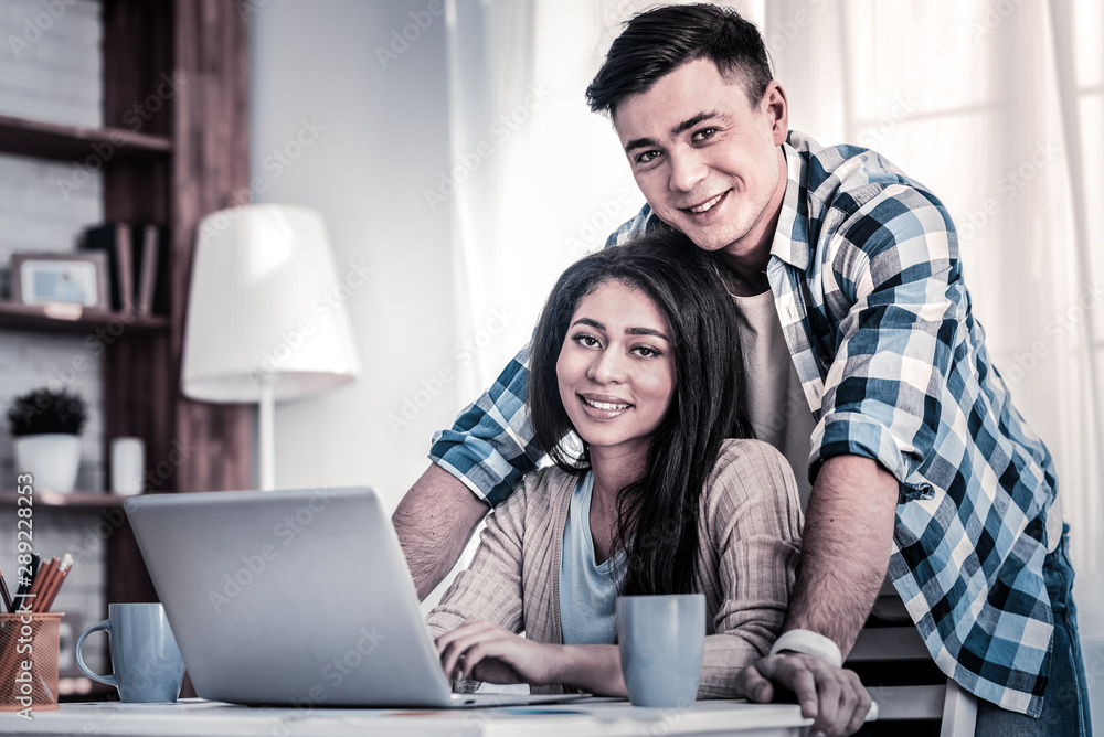 Mixed race young lady sitting on the chair with her boyfriend Mixed race young lady sitting on the chair with her boyfriend
