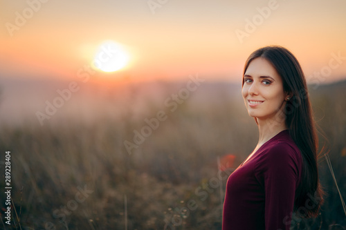 Fashion Portrait of a Happy Woman Admiring Sunset 