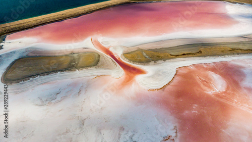 Amazing drone panoramic aerial landscape of beautiful salt plains. pink lake. Bright red salt deposits in artificial salt evaporators, salt mining