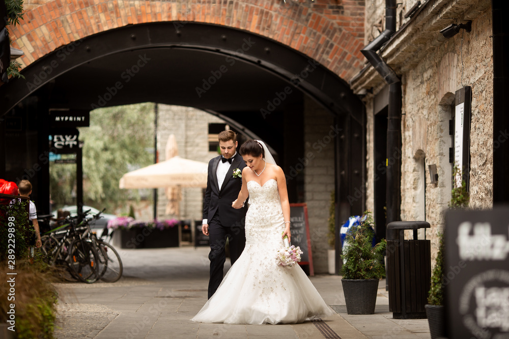 Bride and groom walking in the city, wedding day, marriage concept. Bride and groom in urban background. young couple in wedding day. Bride and groom walking in the city, wedding day, marriage concept. Bride and groom in urban background. young couple in wedding day.