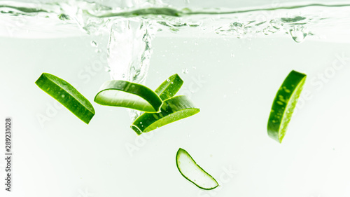 Aloe vera splashing in some water on white background