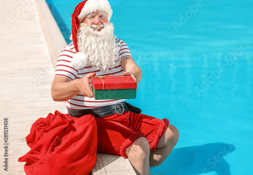 Santa Claus with gift near ...