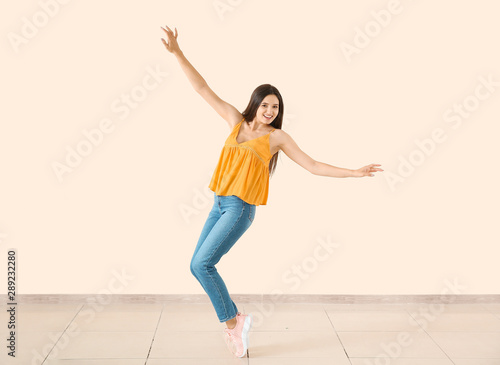 Dancing young woman against...