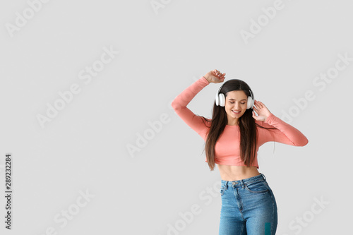 Beautiful young woman liste...