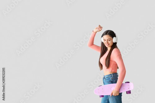Dancing young woman with sk...