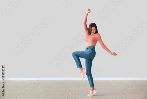 Dancing young woman against...