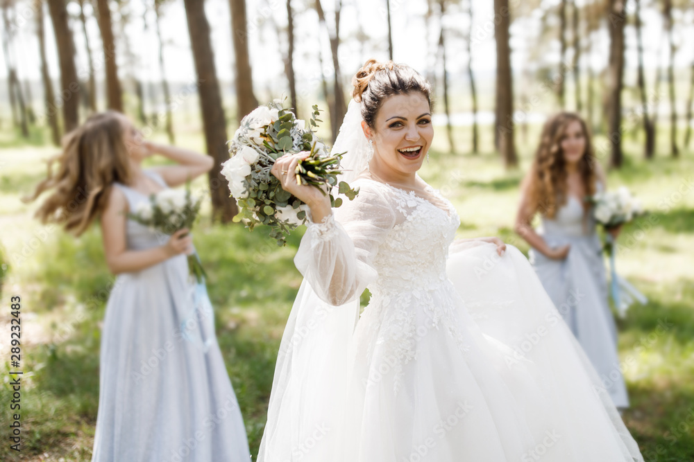 Wedding day. The bride has fun outdoors on her wedding day with her girlfriends