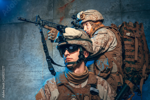 Two well equipped US army commandos armed with assault rifles. Studio shot