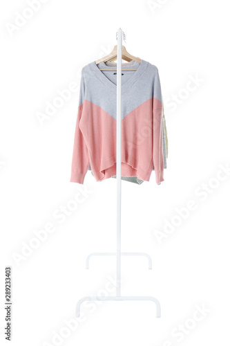 Rack with hanging clothes on white background