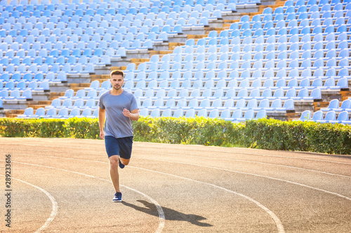 Sporty man running at the s...